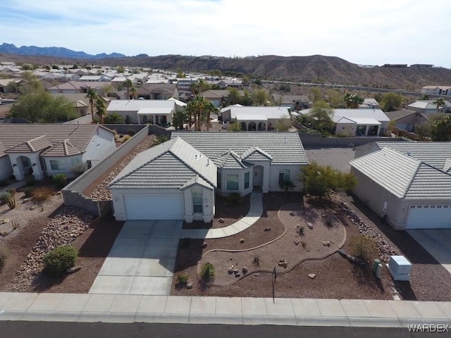 drone / aerial view with a residential view and a mountain view