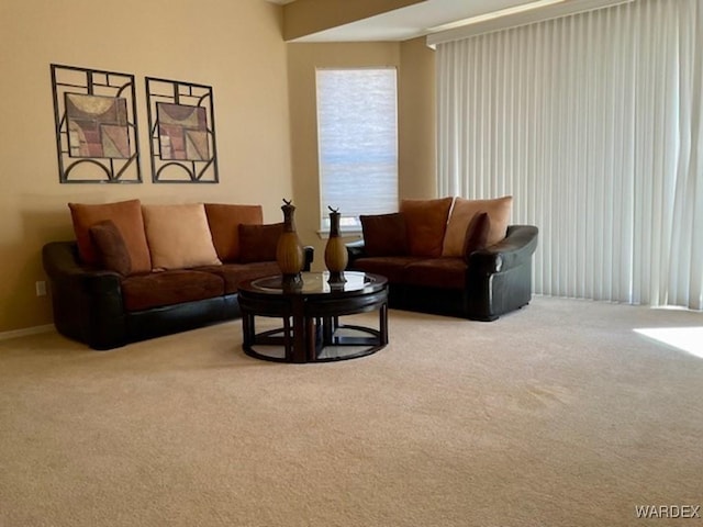 living room featuring light carpet and baseboards