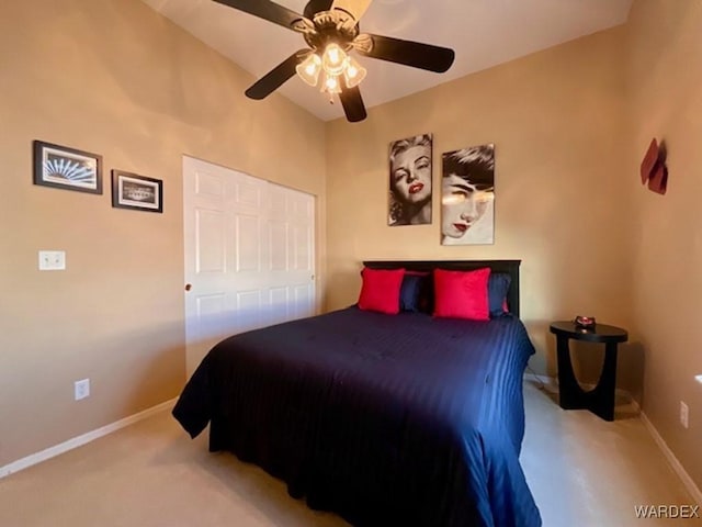 bedroom with light carpet, a ceiling fan, and baseboards