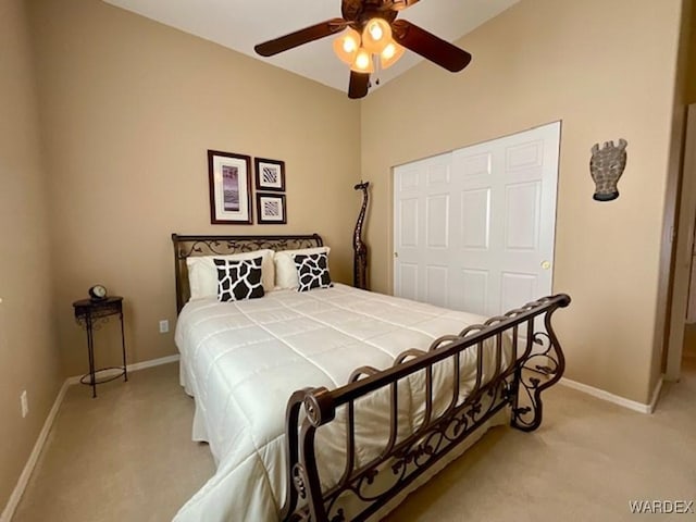 bedroom with ceiling fan, baseboards, and light colored carpet