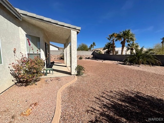 view of yard with a fenced backyard and a patio