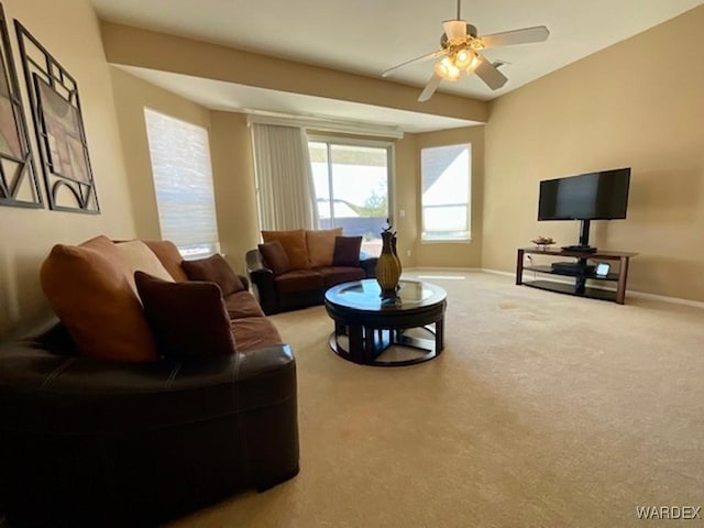 living area with carpet floors, ceiling fan, and baseboards