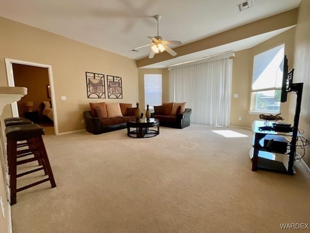 living room featuring light carpet, ceiling fan, visible vents, and baseboards