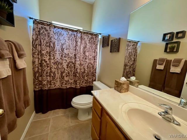 bathroom with a shower with shower curtain, vanity, toilet, and tile patterned floors