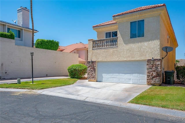 view of front of house featuring a garage, concrete driveway, stone siding, a tile roof, and stucco siding