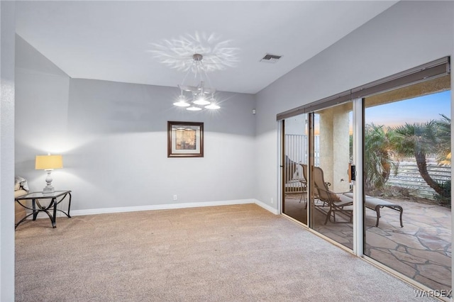 empty room featuring baseboards, visible vents, carpet flooring, and an inviting chandelier