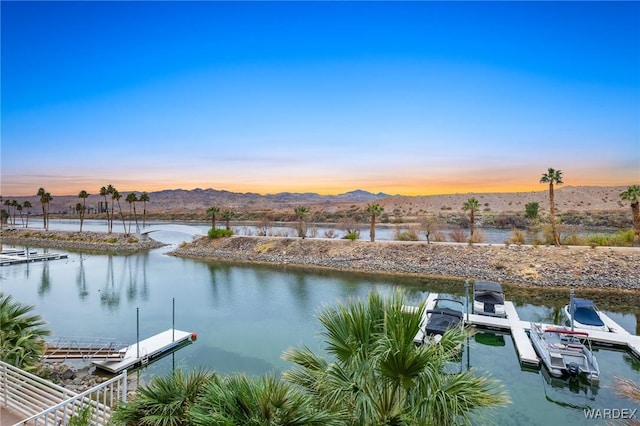 view of water feature with a floating dock and a mountain view