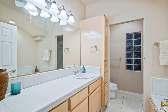 bathroom featuring toilet, tile patterned flooring, baseboards, and vanity