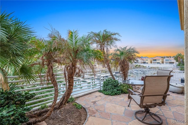 view of patio terrace at dusk