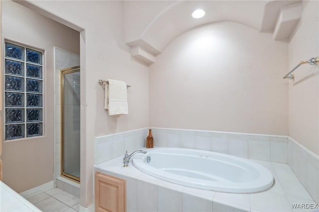 full bathroom featuring tile patterned flooring, a garden tub, and a shower stall