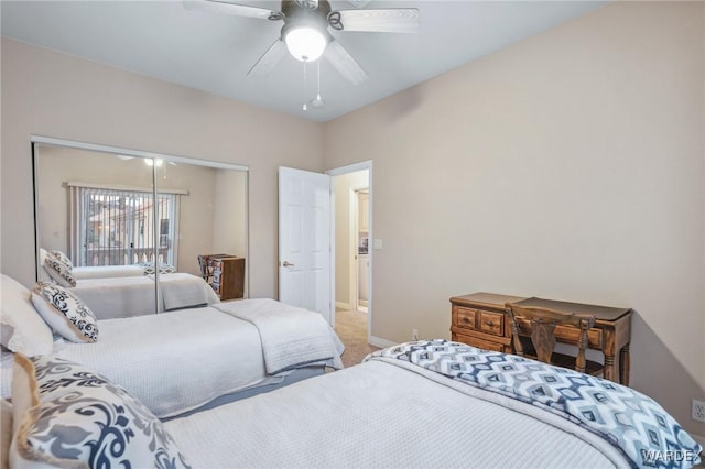 carpeted bedroom with a closet, ceiling fan, and baseboards