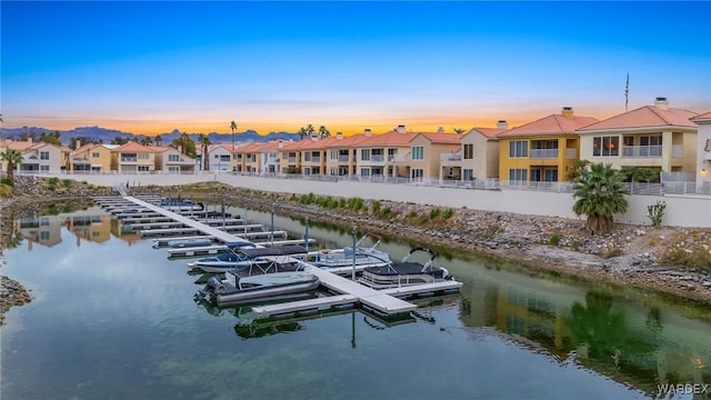 exterior space featuring a floating dock and a residential view