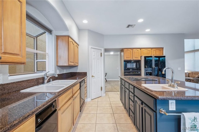 kitchen featuring light tile patterned floors, black appliances, a sink, and visible vents