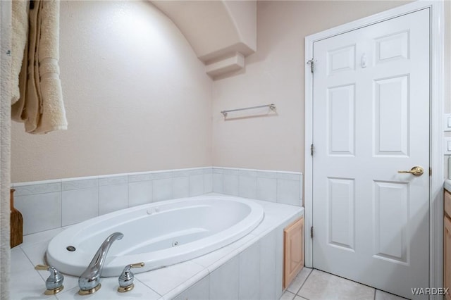 full bathroom with a bath, tile patterned flooring, and vanity