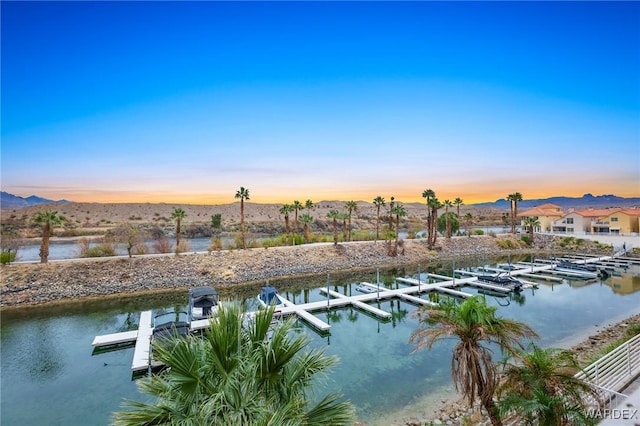 property view of water featuring a boat dock and a mountain view