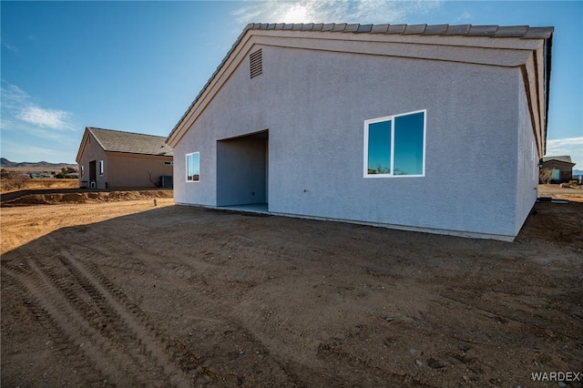 rear view of house with stucco siding