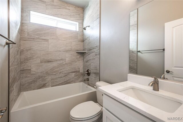 full bathroom featuring toilet, washtub / shower combination, and vanity