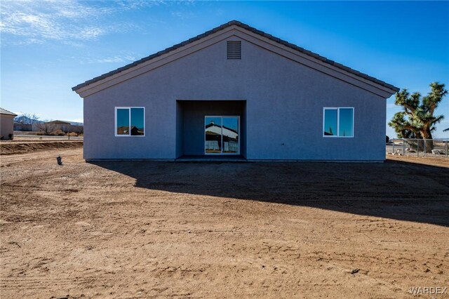 back of house featuring stucco siding