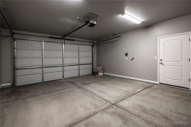 garage featuring baseboards and a garage door opener