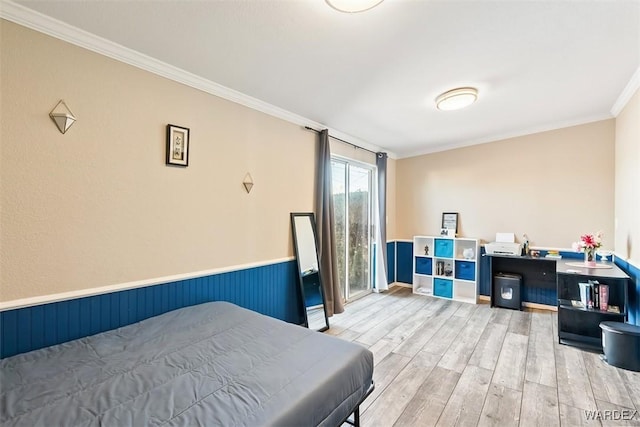 bedroom with light wood finished floors, access to outside, crown molding, and wainscoting