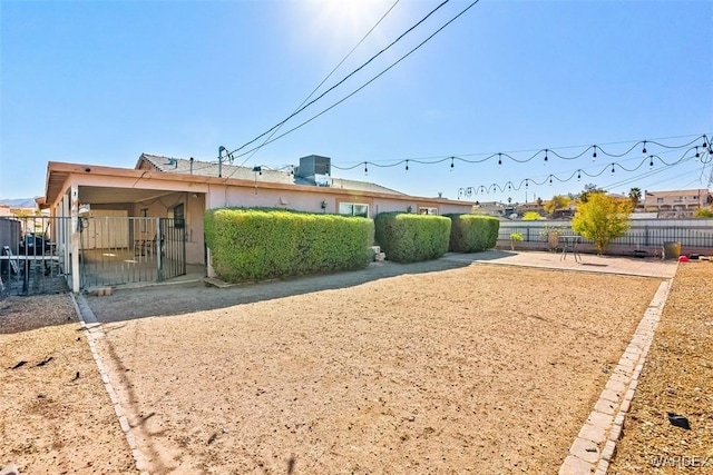 view of yard featuring fence and a patio