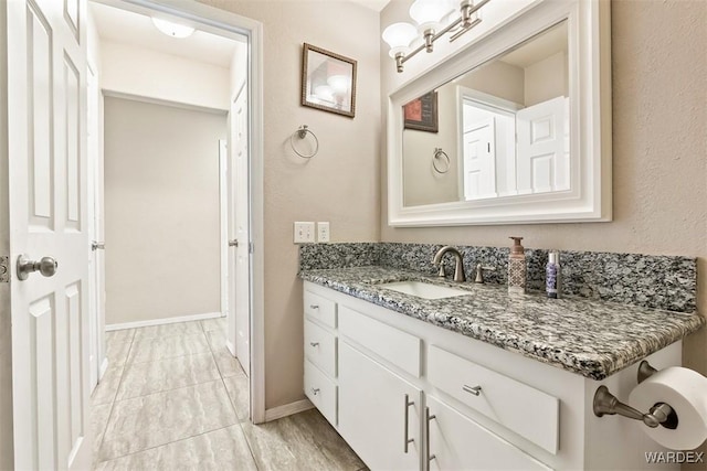 bathroom featuring vanity and baseboards