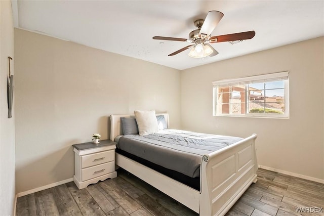 bedroom featuring light wood-type flooring, baseboards, and a ceiling fan