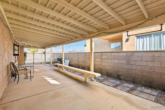 view of patio with a grill and fence