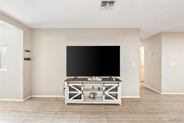 tiled living area featuring visible vents and baseboards