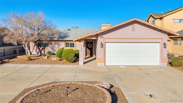 single story home featuring an attached garage, fence, driveway, stucco siding, and a chimney