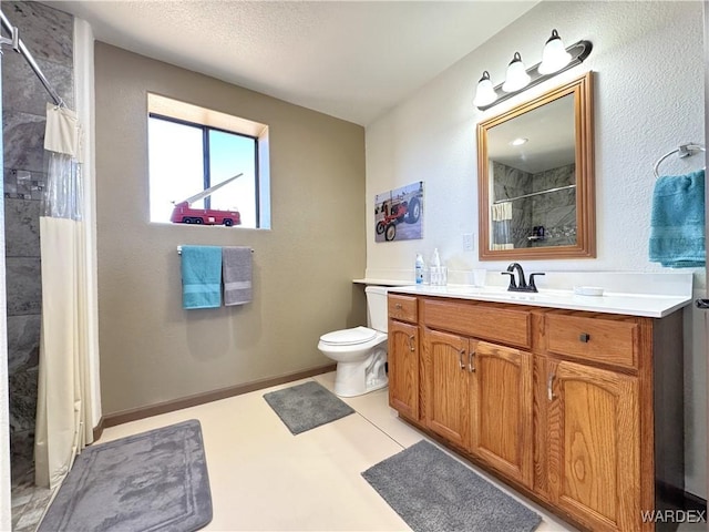 bathroom with curtained shower, baseboards, toilet, and vanity