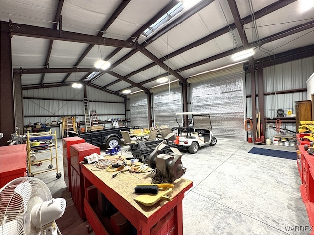 garage featuring a workshop area and metal wall