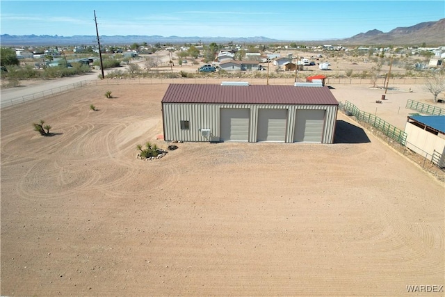 view of outdoor structure featuring an outdoor structure, fence, and a mountain view