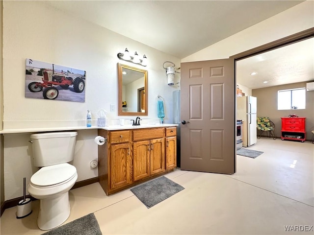 bathroom with a wall mounted air conditioner, toilet, baseboards, vanity, and vaulted ceiling