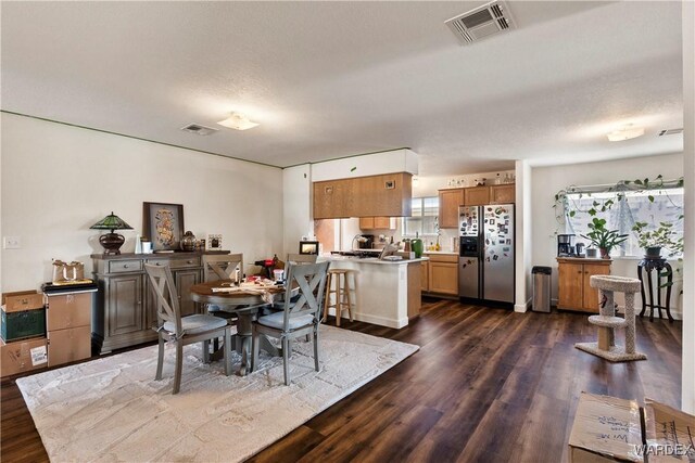 dining room featuring visible vents and dark wood finished floors