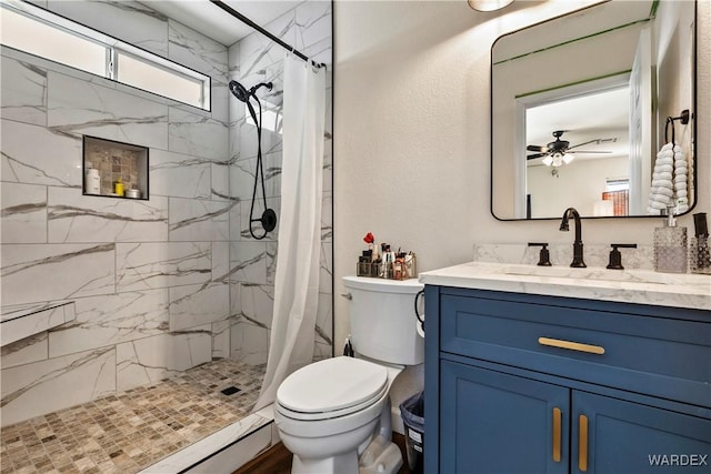 bathroom with toilet, a textured wall, a marble finish shower, and vanity