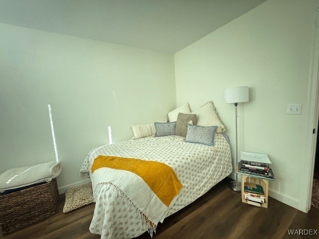 bedroom with dark wood-style floors and baseboards