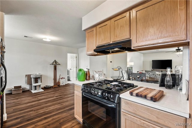 kitchen with visible vents, dark wood finished floors, light countertops, black gas stove, and under cabinet range hood