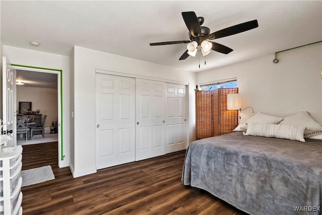 bedroom featuring ceiling fan, dark wood-type flooring, a closet, and baseboards