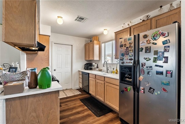 kitchen featuring dishwasher, stainless steel refrigerator with ice dispenser, a sink, and light countertops