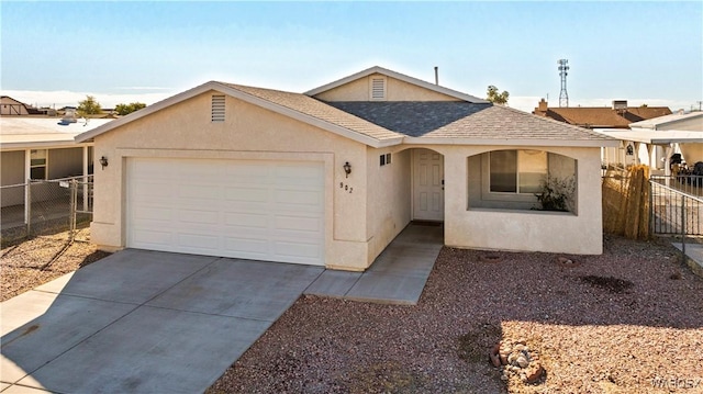 single story home featuring a garage, concrete driveway, fence, and stucco siding