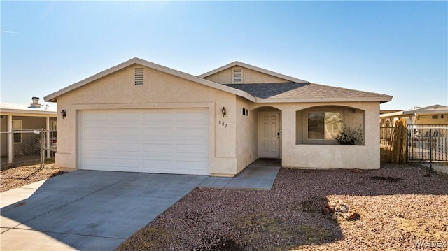 single story home featuring driveway, roof with shingles, an attached garage, fence, and stucco siding