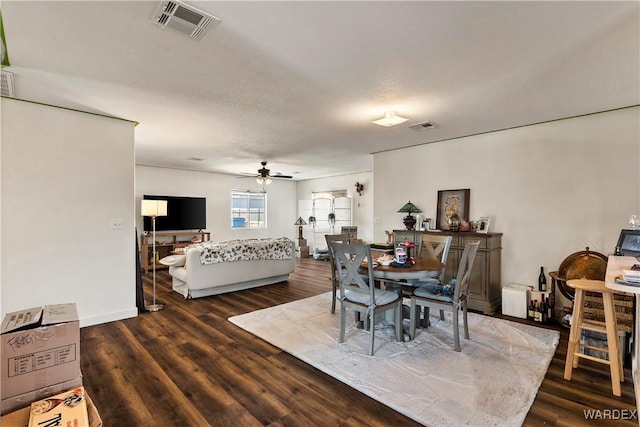 dining room featuring dark wood-type flooring, visible vents, and a ceiling fan