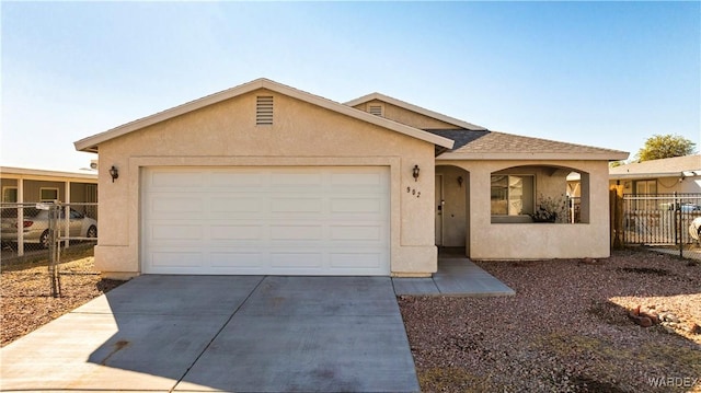 ranch-style house featuring stucco siding, a shingled roof, an attached garage, fence, and driveway