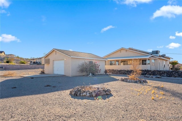 single story home with a garage and stucco siding