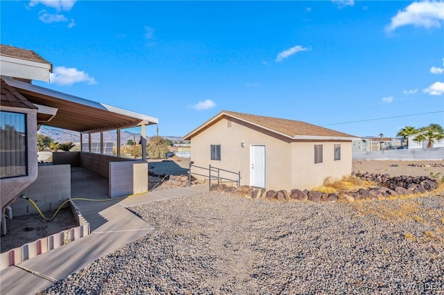 view of property exterior with a patio and stucco siding