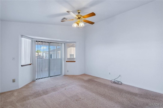 empty room featuring visible vents, a ceiling fan, and light colored carpet