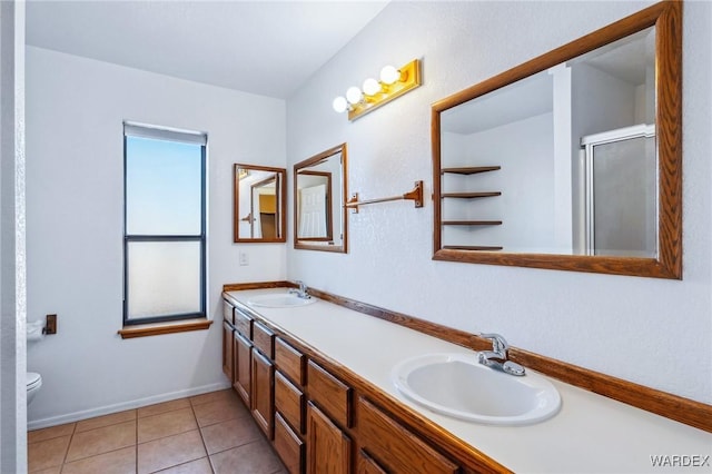 bathroom featuring a healthy amount of sunlight, a sink, and tile patterned floors