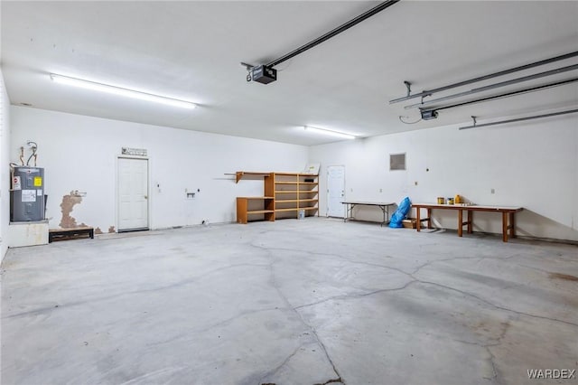 garage featuring water heater and a garage door opener