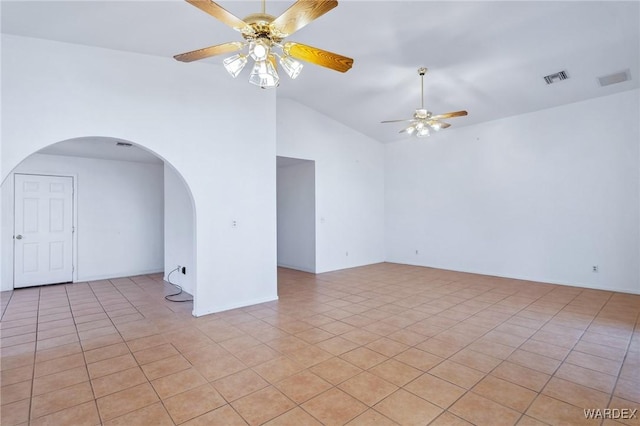 empty room with a ceiling fan, arched walkways, visible vents, and high vaulted ceiling